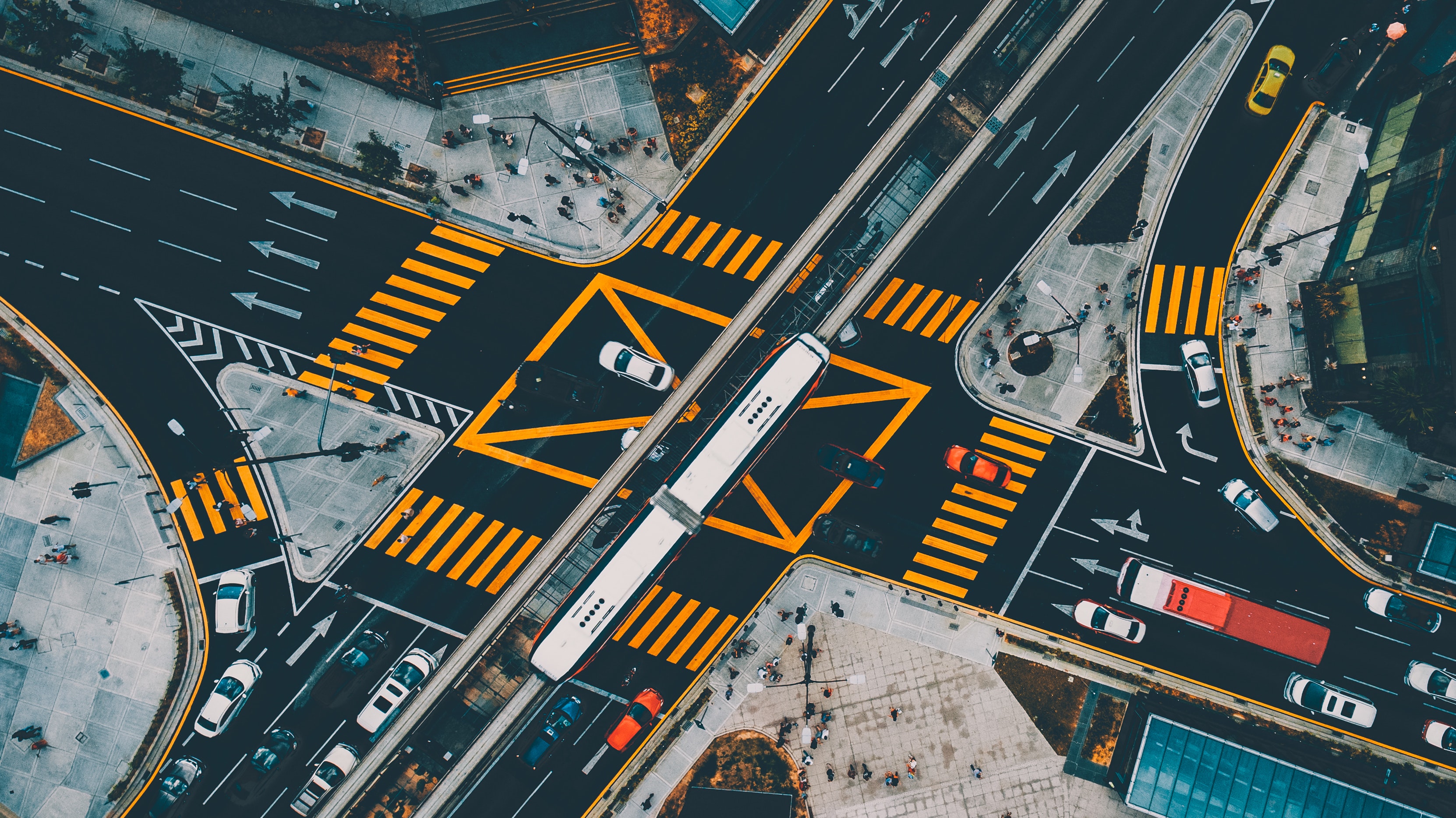 A photo of a large and well-traveled, perpendicular street intersection in Kuala Lumpur, Malaysia.